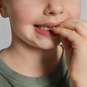 Closeup of child biting their nails