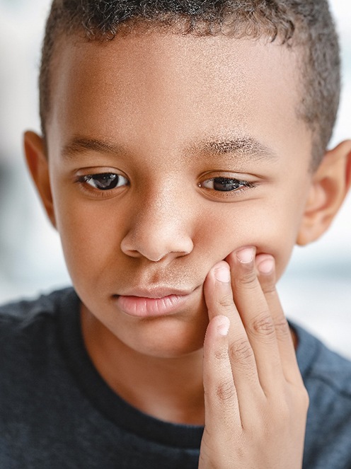 Closeup of child experiencing toothache