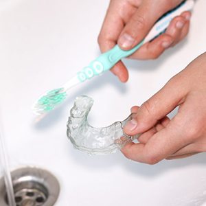 Athletic mouthguard being brushed