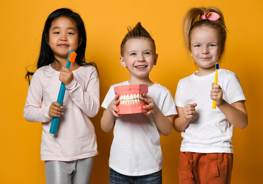 Kids holding dentist props